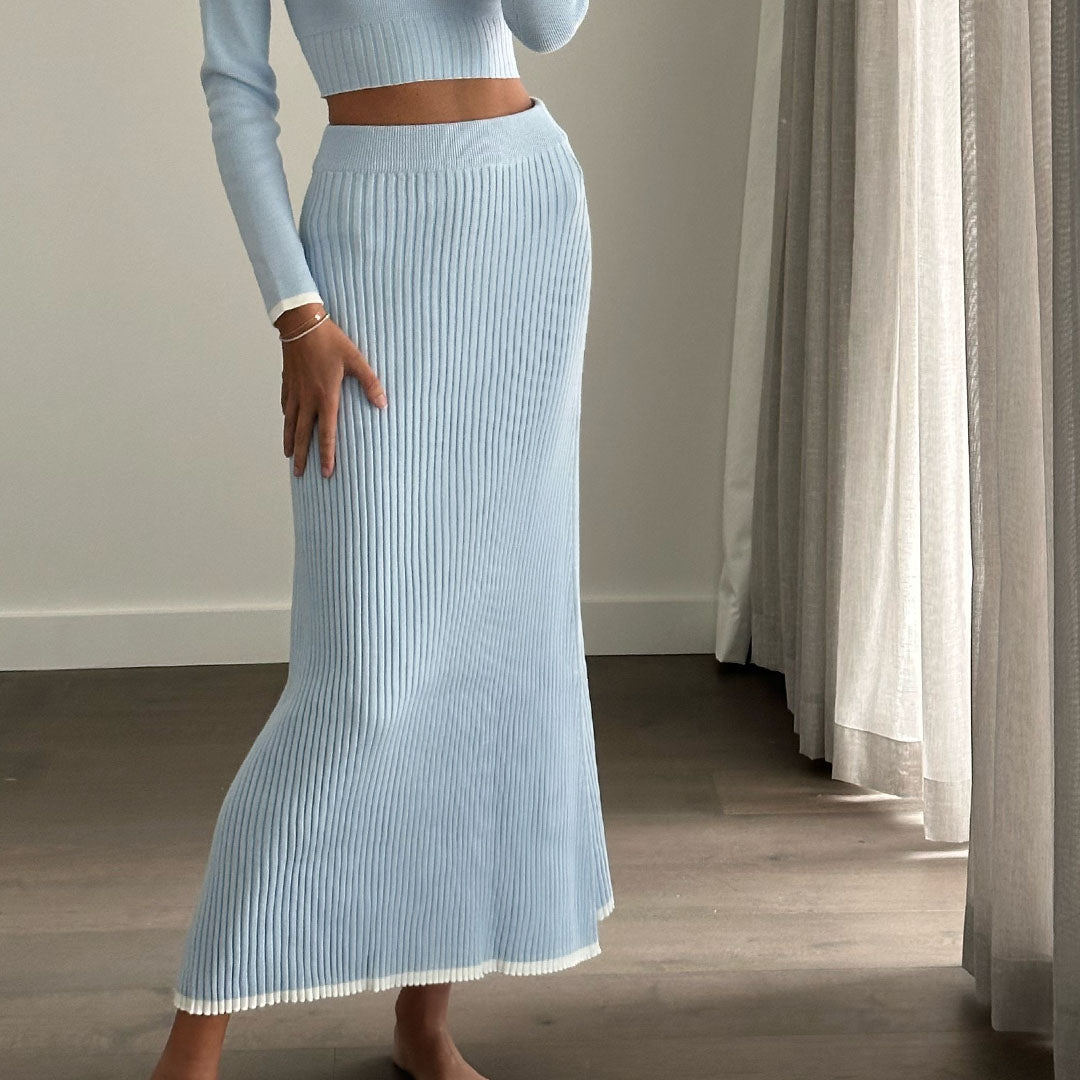 Female model online wearing baby blue knit high waist pleated maxi skirt