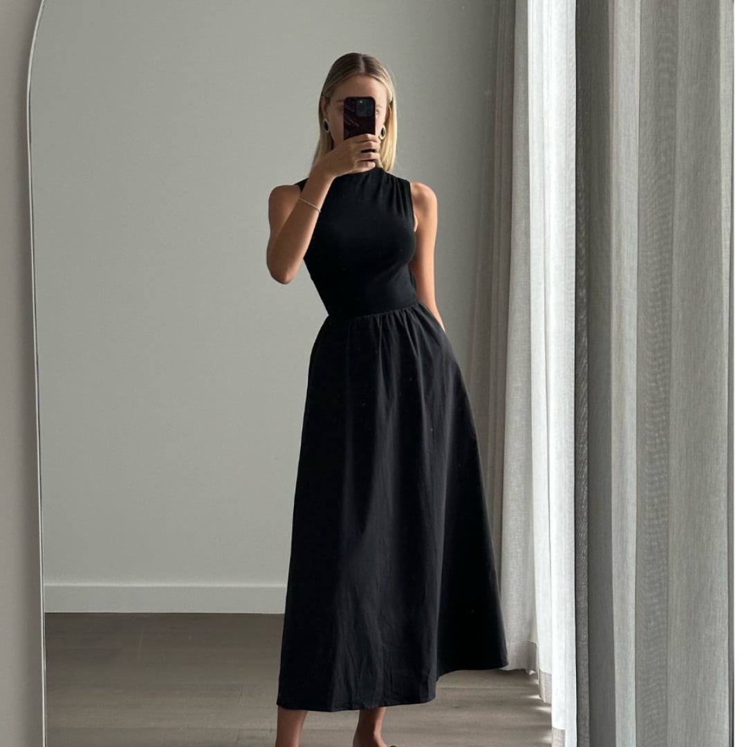 Female model online wearing black high neck sleeveless princess cut midi dress