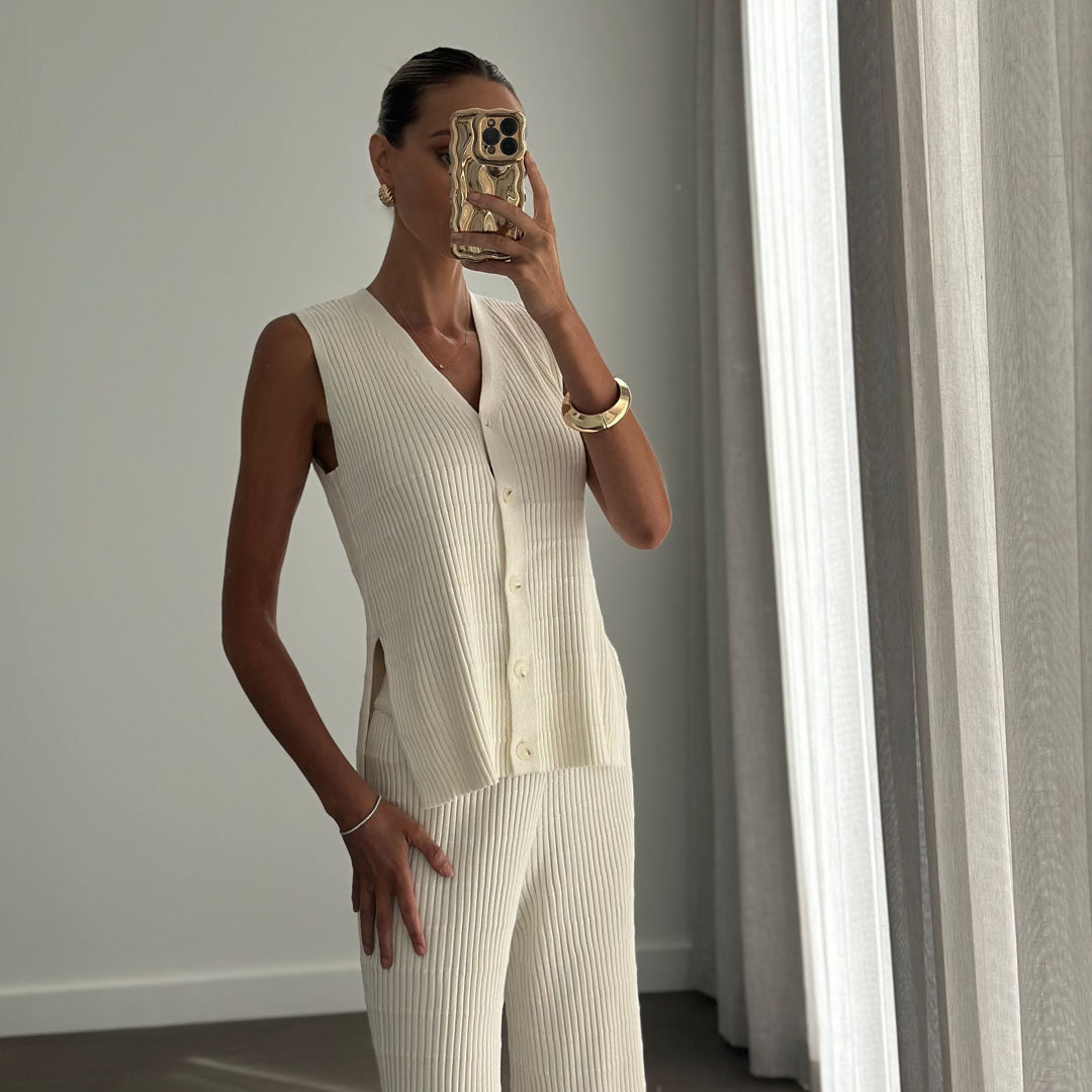 Female model wearing beige knitted button up sleeveless vest top