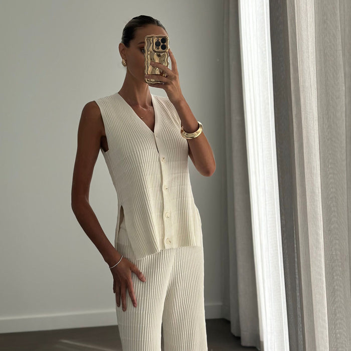 Female model wearing beige knitted button up sleeveless vest top