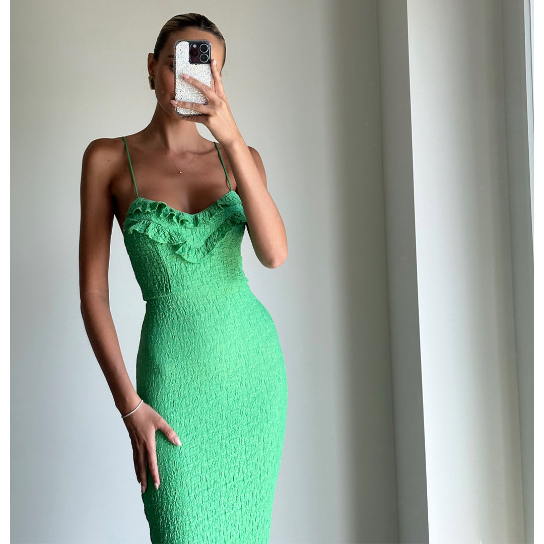 Female model online wearing vibrant green strappy bodycon midi dress