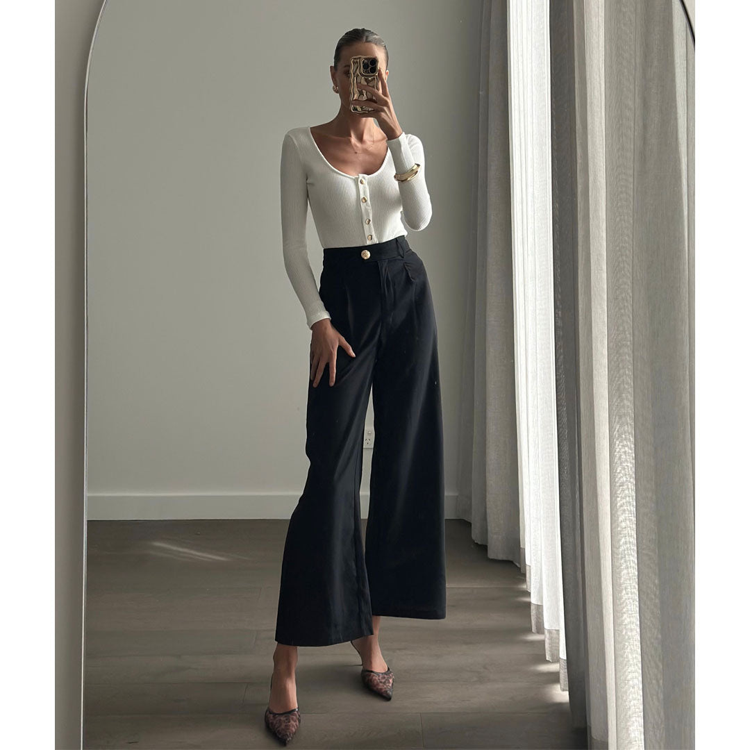 Female model online wearing white long sleeve button up bodysuit