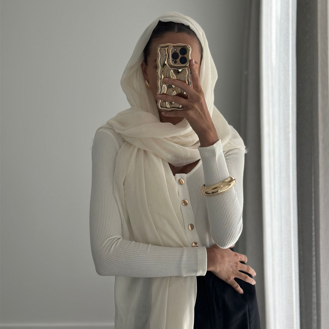 Female model online wearing white long sleeve button up bodysuit