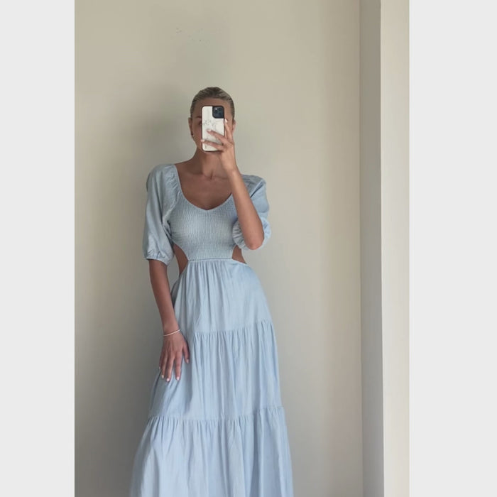 Female model wearing baby blue puff sleeve open back flowy maxi dress