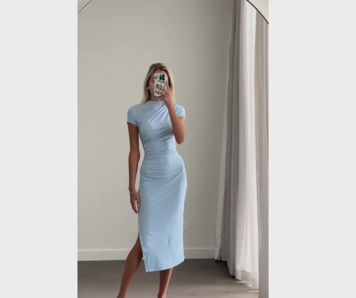 Female model wearing baby blue crew neck short sleeve fitted midi dress