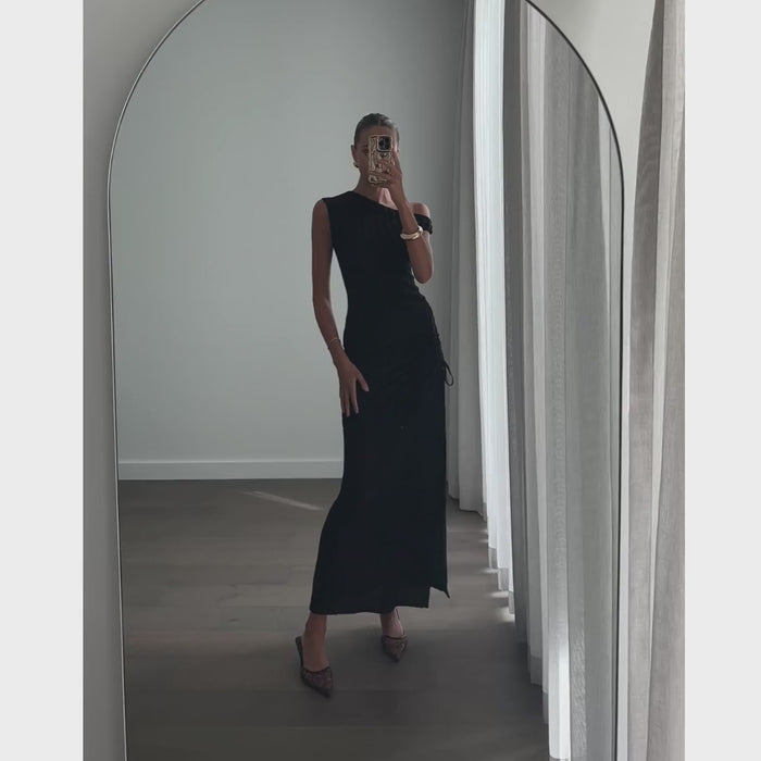 Female model wearing black off shoulder side split maxi dress