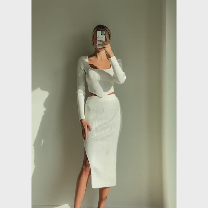 Female model online wearing white triangle cut knit crop top