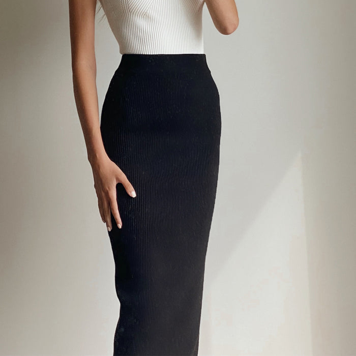 Female model wearing black knit midi skirt with side split