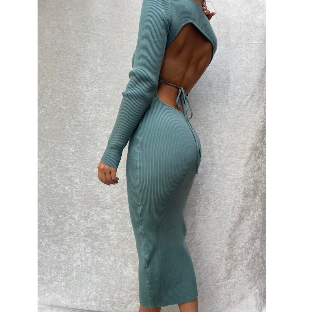 Female model wearing teal long sleeve bodycon open back midi dress
