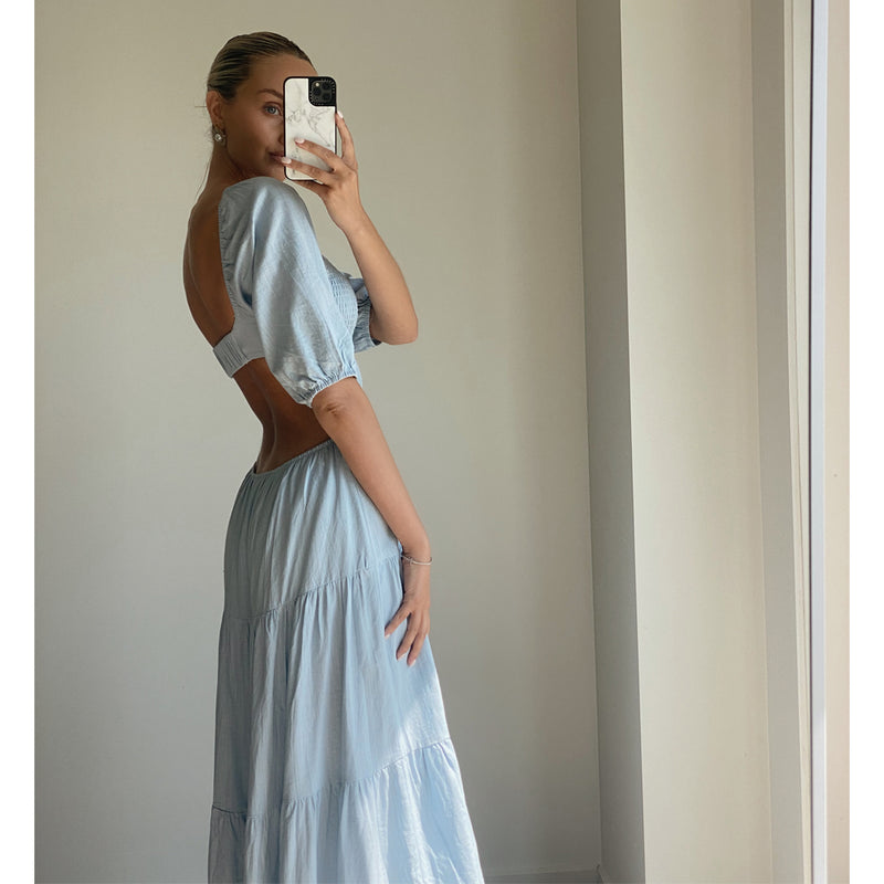 Female model wearing baby blue puff sleeve open back flowy maxi dress