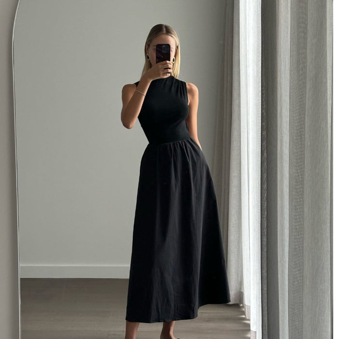 Female model online wearing black high neck sleeveless princess cut midi dress 