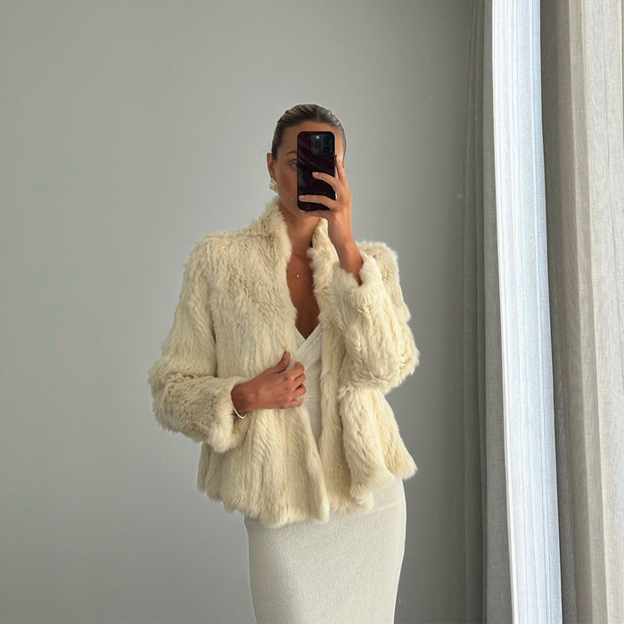 Female model online wearing long sleeve ivory fur jacket 