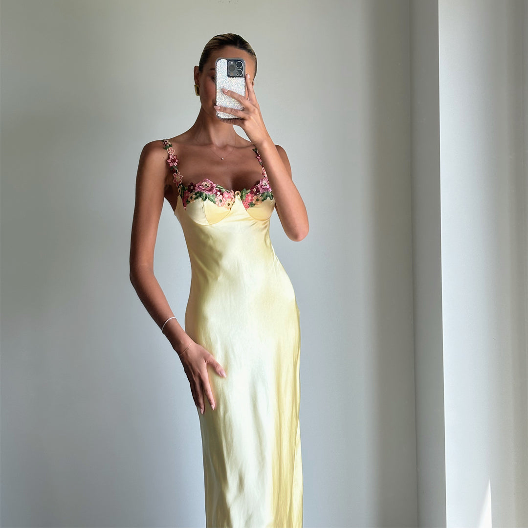 Female model online wearing soft yellow strappy bustier maxi dress