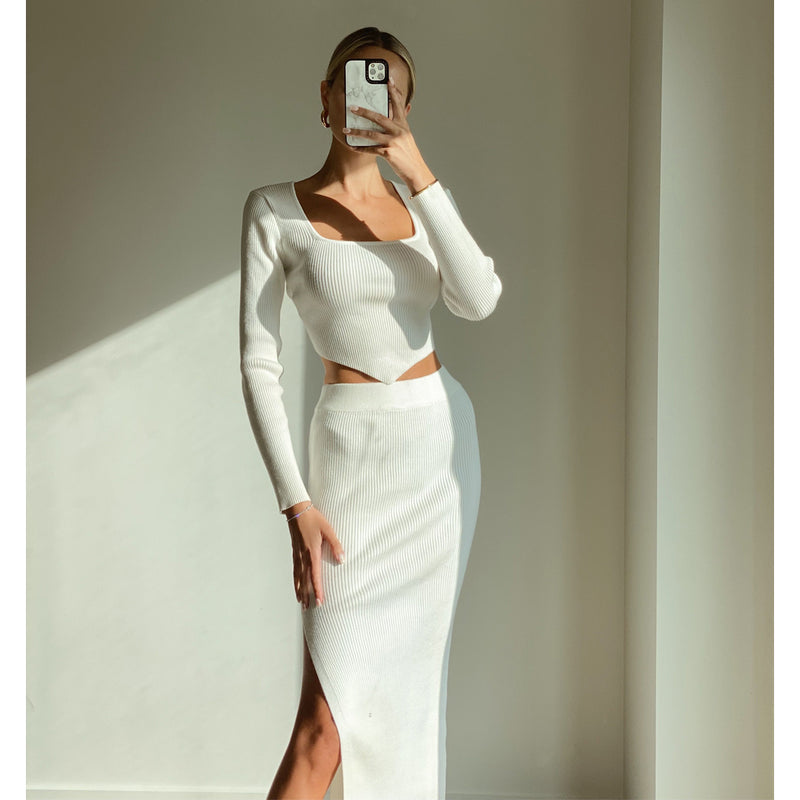Female model online wearing white triangle cut knit crop top