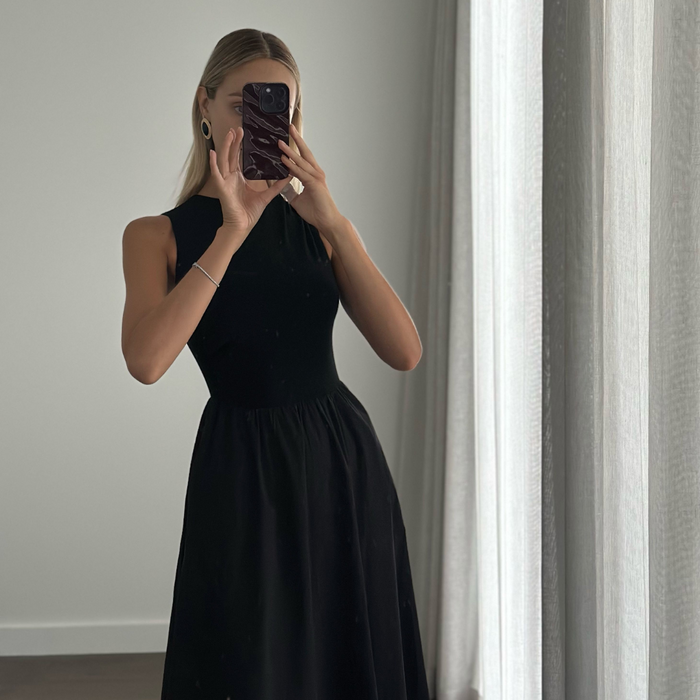 Female model online wearing black high neck sleeveless princess cut midi dress 