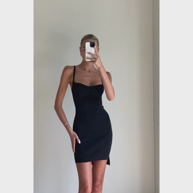 Female model online wearing black mini stappy knit dress