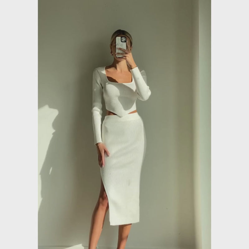 Female model online wearing white triangle cut knit crop top
