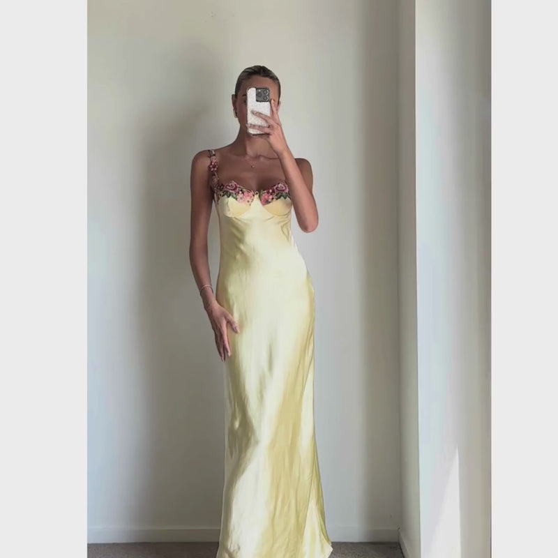 Female model online wearing soft yellow strappy bustier maxi dress