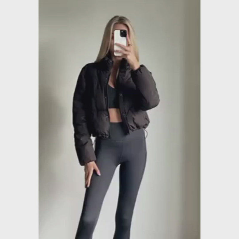 Female model wearing black cropped puffer jacket