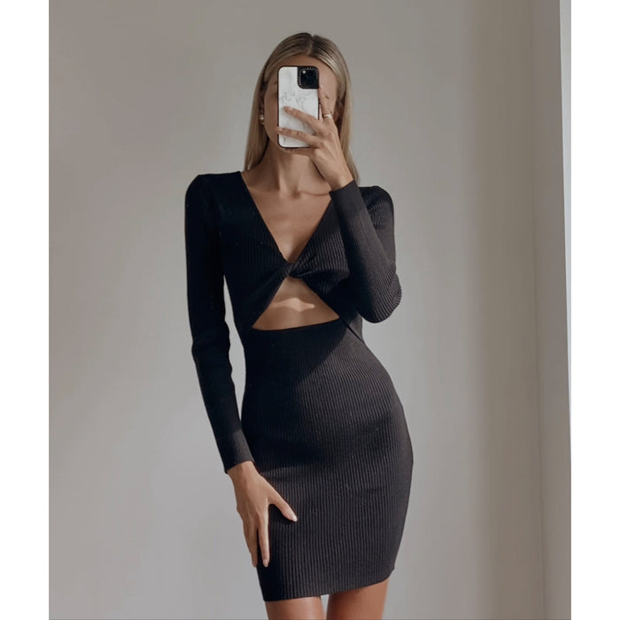 Female model wearing black long sleeve knit mini dress