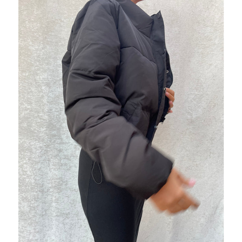 Female model wearing black cropped puffer jacket