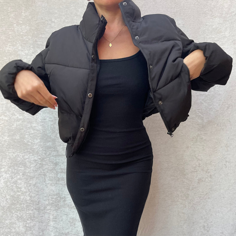 Female model wearing black cropped puffer jacket