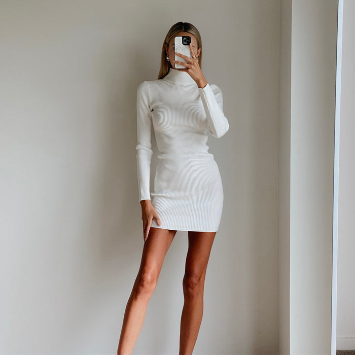 Female model wearing white high neck long sleeve bodycon mini dress