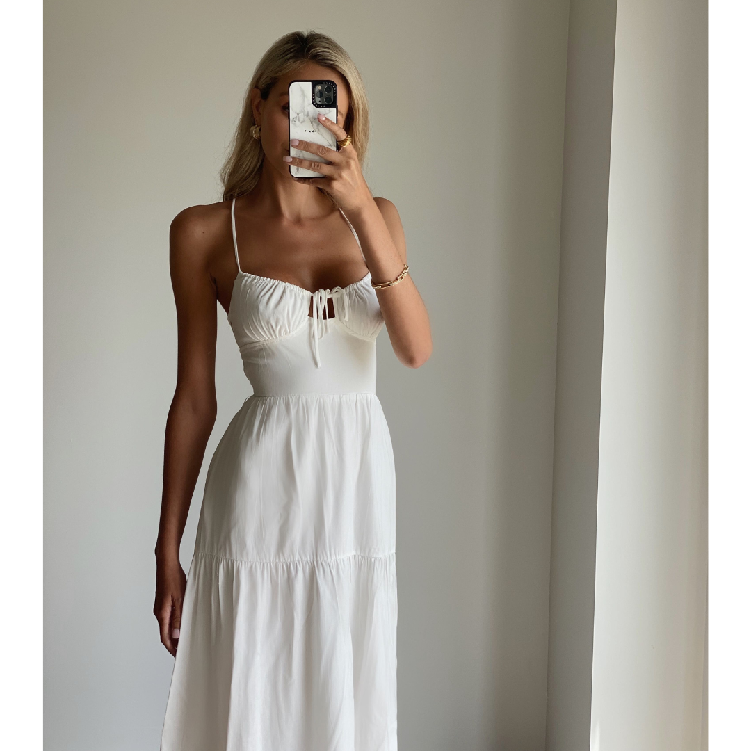 Female model online wearing white strappy flowy maxi dress