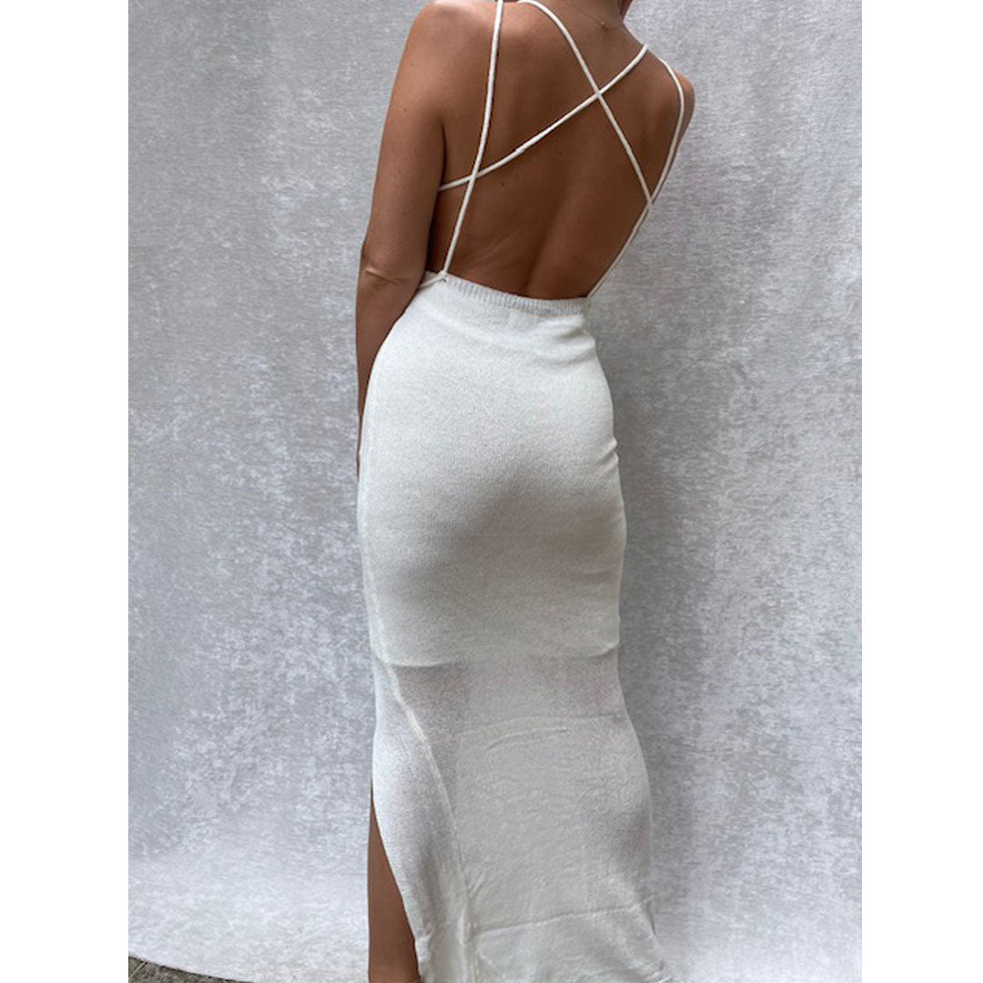 Female model online wearing ivory knit backless maxi dress with front split detail