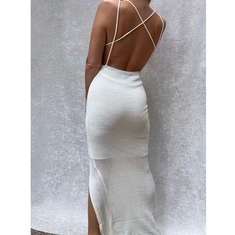 Female model online wearing ivory knit backless maxi dress with front split detail