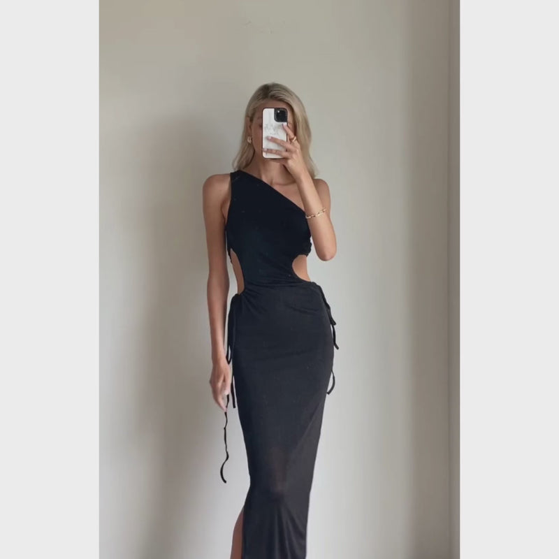 Female model online wearing black one shoulder side cut out maxi dress