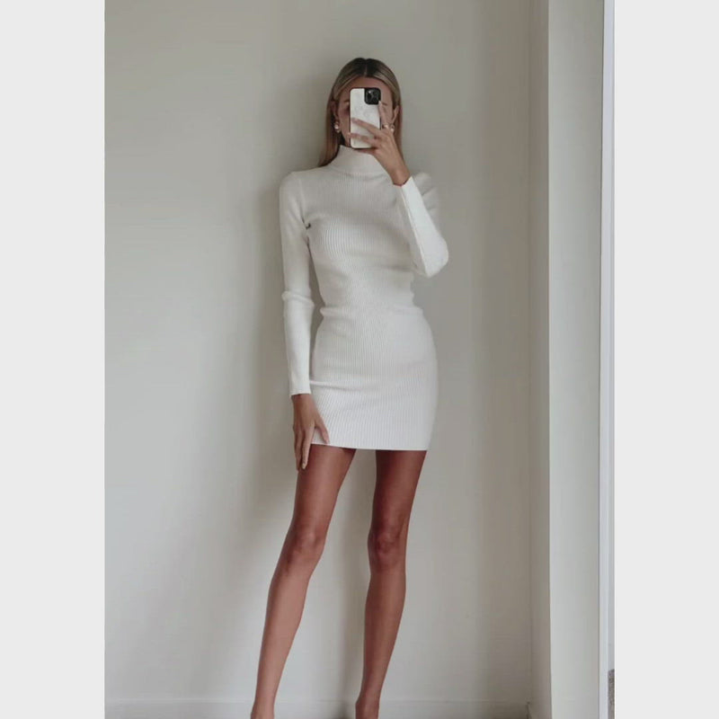 Female model wearing white high neck long sleeve bodycon mini dress